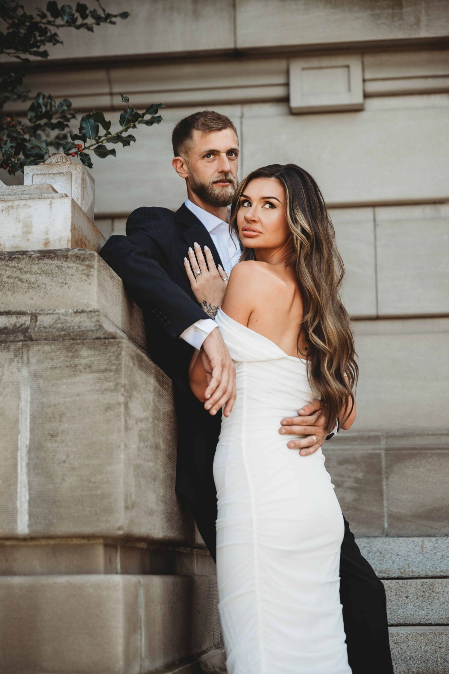 A bride and groom standing in front of the Walla Walla courthouse after their wedding ceremony.