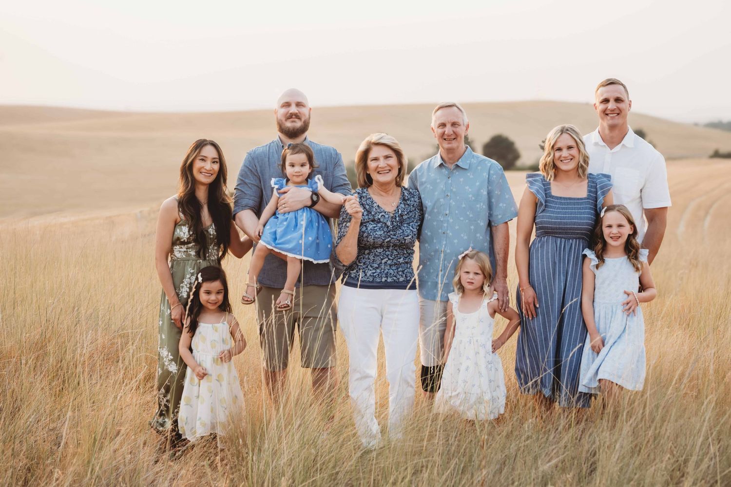 An extended family standing in a field looking at the camera.