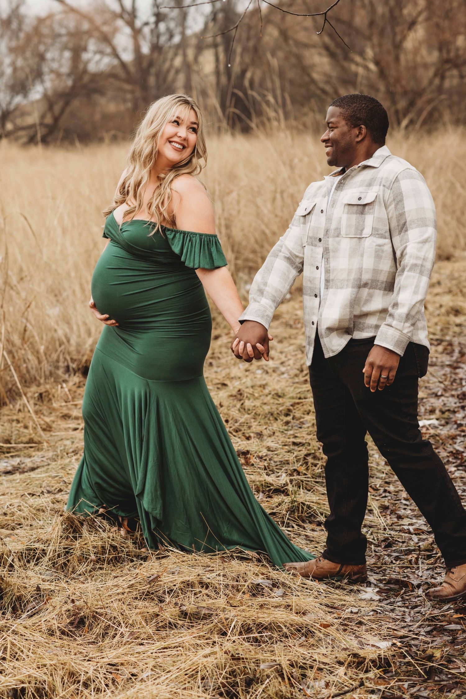 A portrait of a pregnant woman walking with her husband through a grassy trail captured by a Walla Walla maternity photographer.