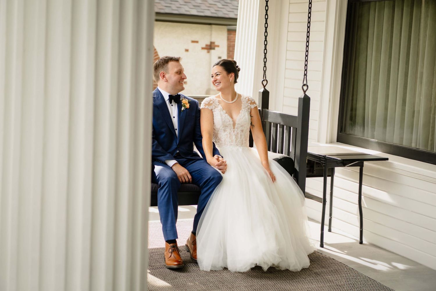 A couple swinging on a porch swing at a pasco Washington mansion wedding venue, taken by a masco wedding photographer
