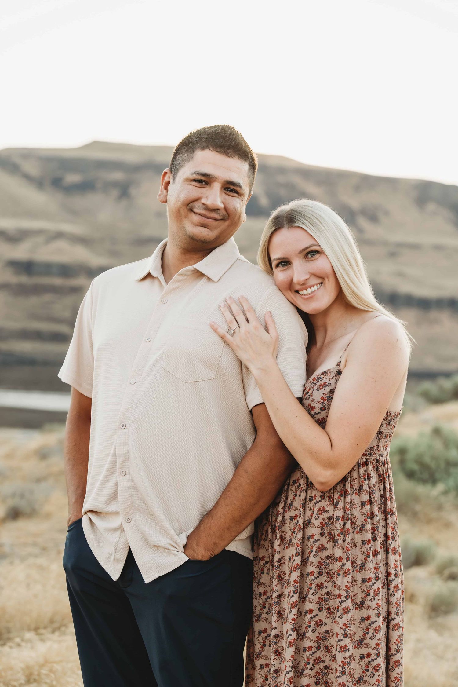 A Walla Walla photographer captures a couple smiling for an engagement portrait at Twin Sisters near Walla Walla.