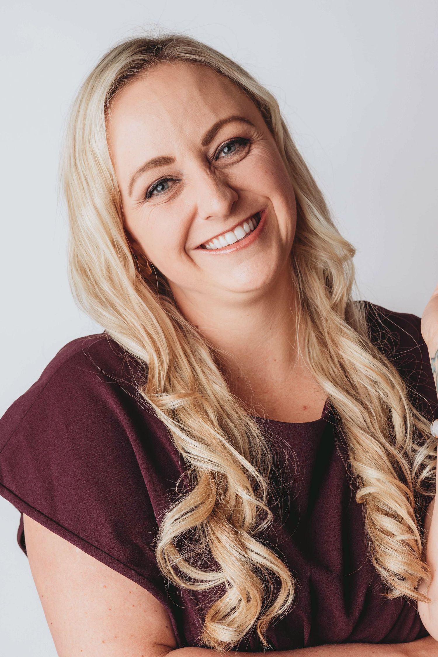 Professional headshot portrait by a Walla Walla photographer, featuring a smiling woman against a clean studio background.