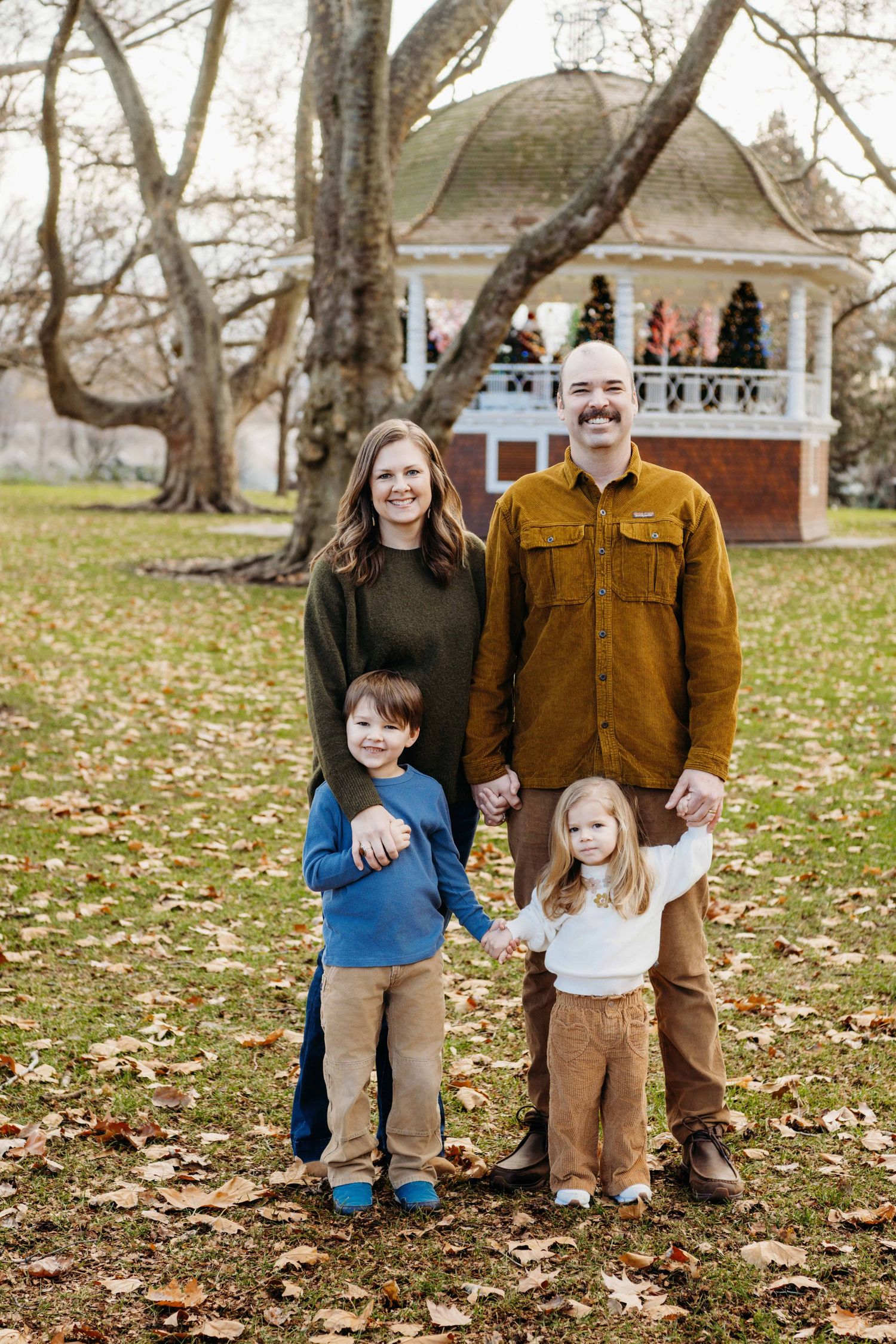 A family of four standing in front of a gazebo at Pioneer Park in Walla Walla, Washington.