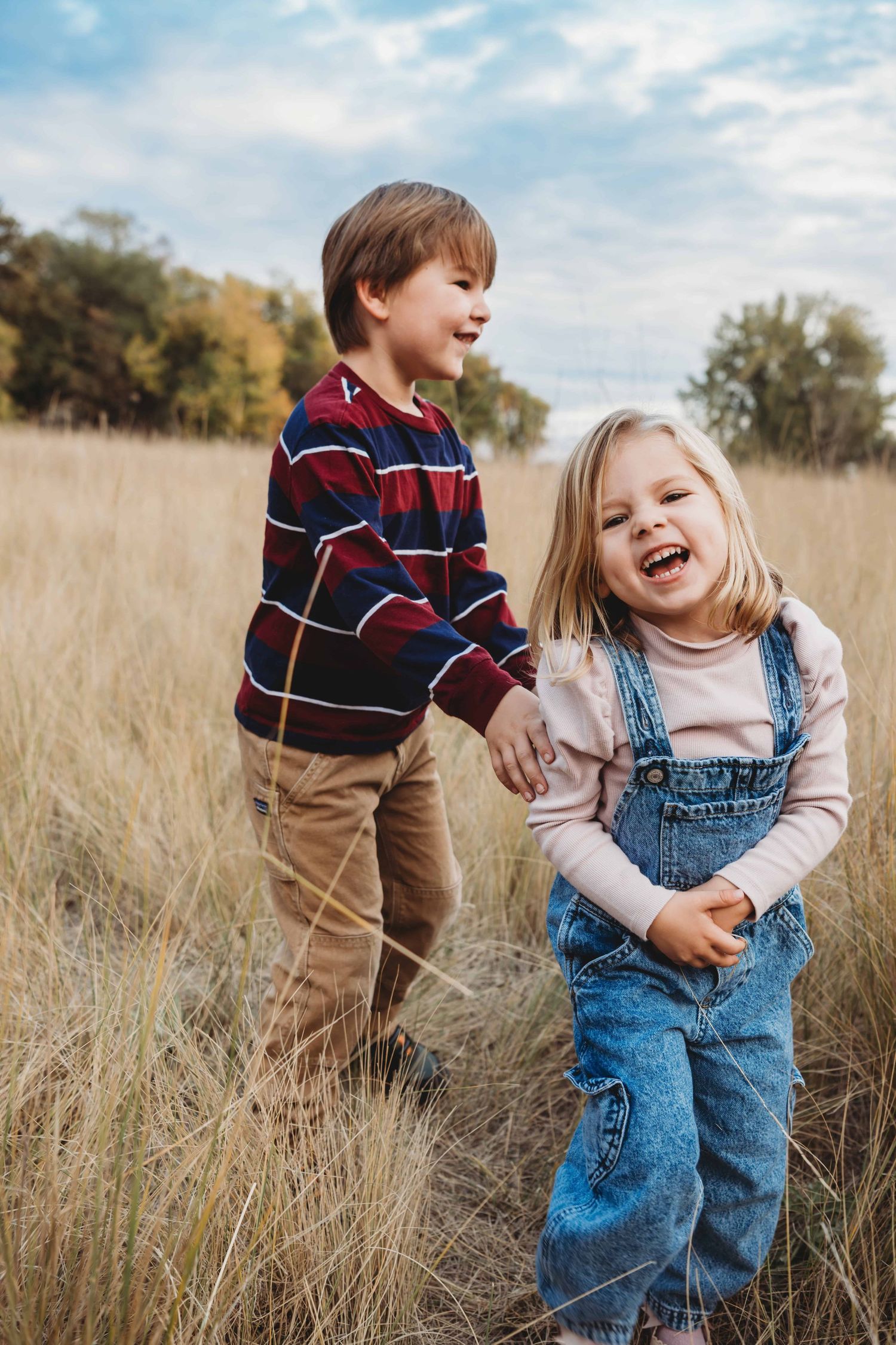 A boy and girl play tag together in a field in Walla Walla.