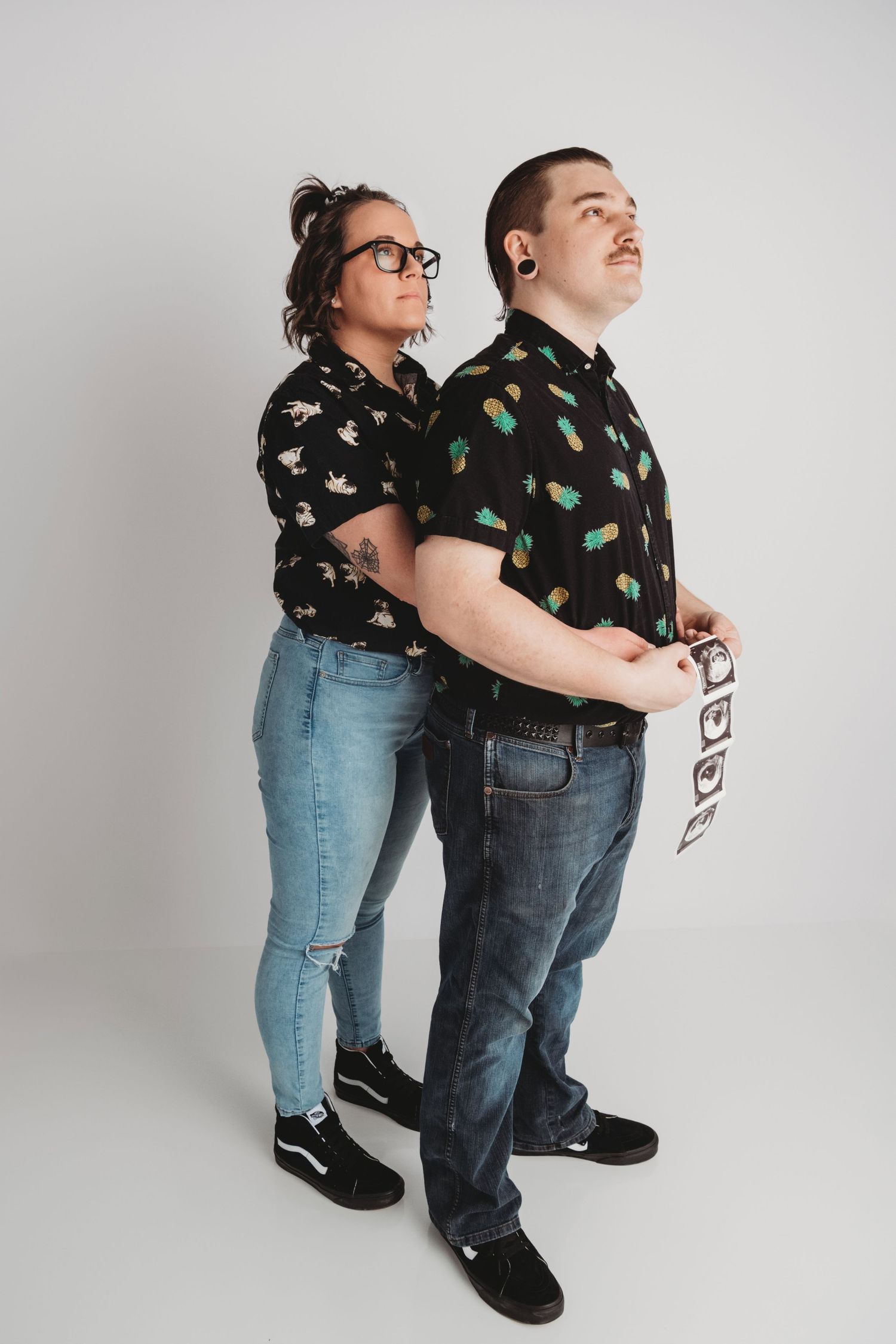 Studio maternity couples portrait with ultrasound photos, captured in a Walla Walla photography studio