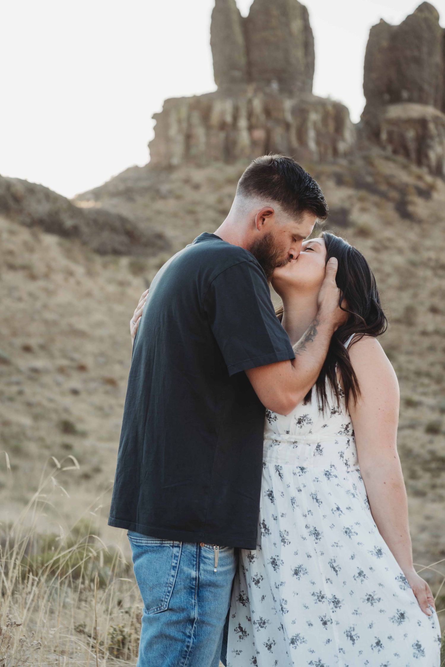 A couple kissing in front of a rock formation at Twin Sisters near Walla Walla, Washington.
