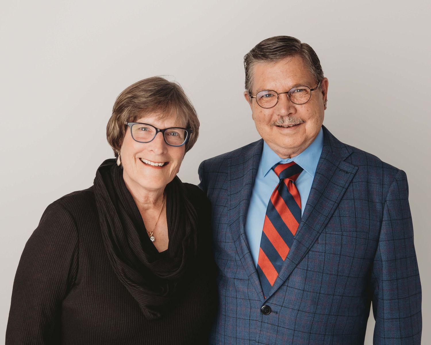 Studio portrait of an older couple smiling together, photographed by a Walla Walla couples photographer on a clean neutral backdrop.