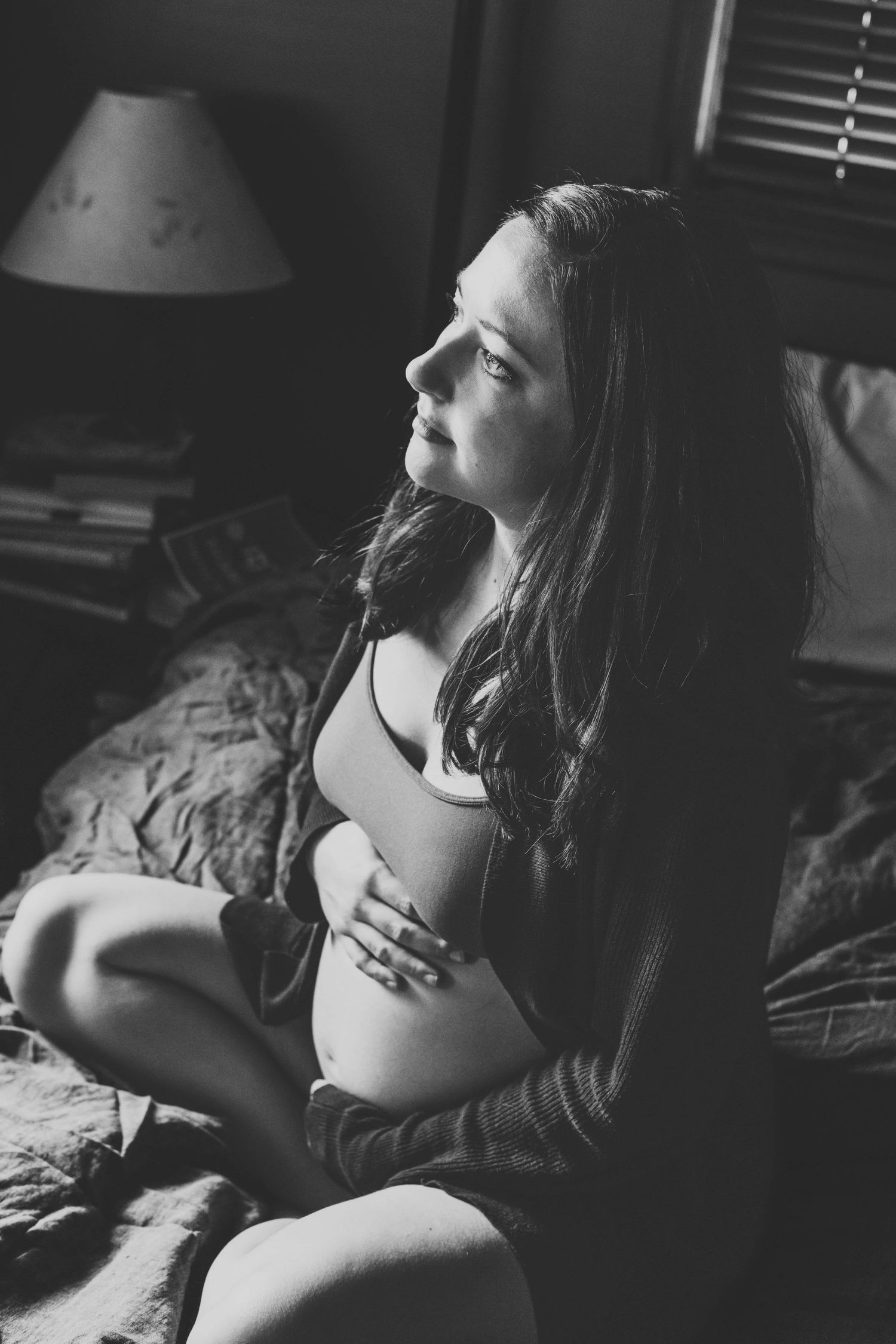 Black and white maternity portrait by a Walla Walla maternity photographer of a pregnant woman resting her hands on her belly.