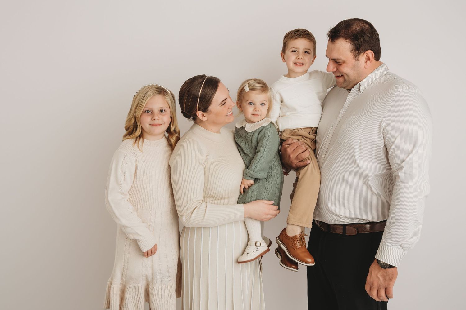 A portrait of a family of five on a white studio backdrop taken by a Walla Walla family photographer.