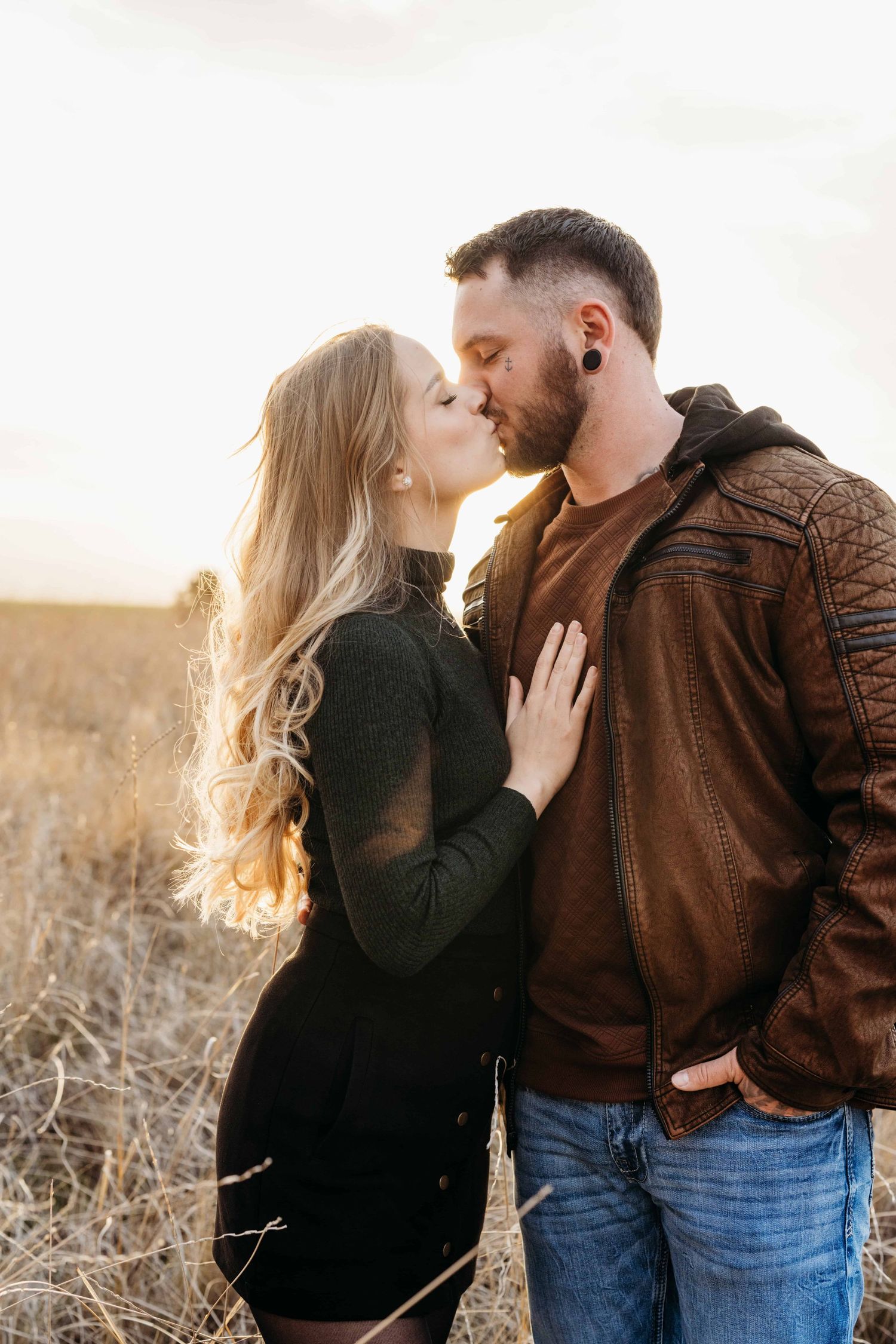 Couple sharing a kiss at sunset during a romantic outdoor couples session in Walla Walla.