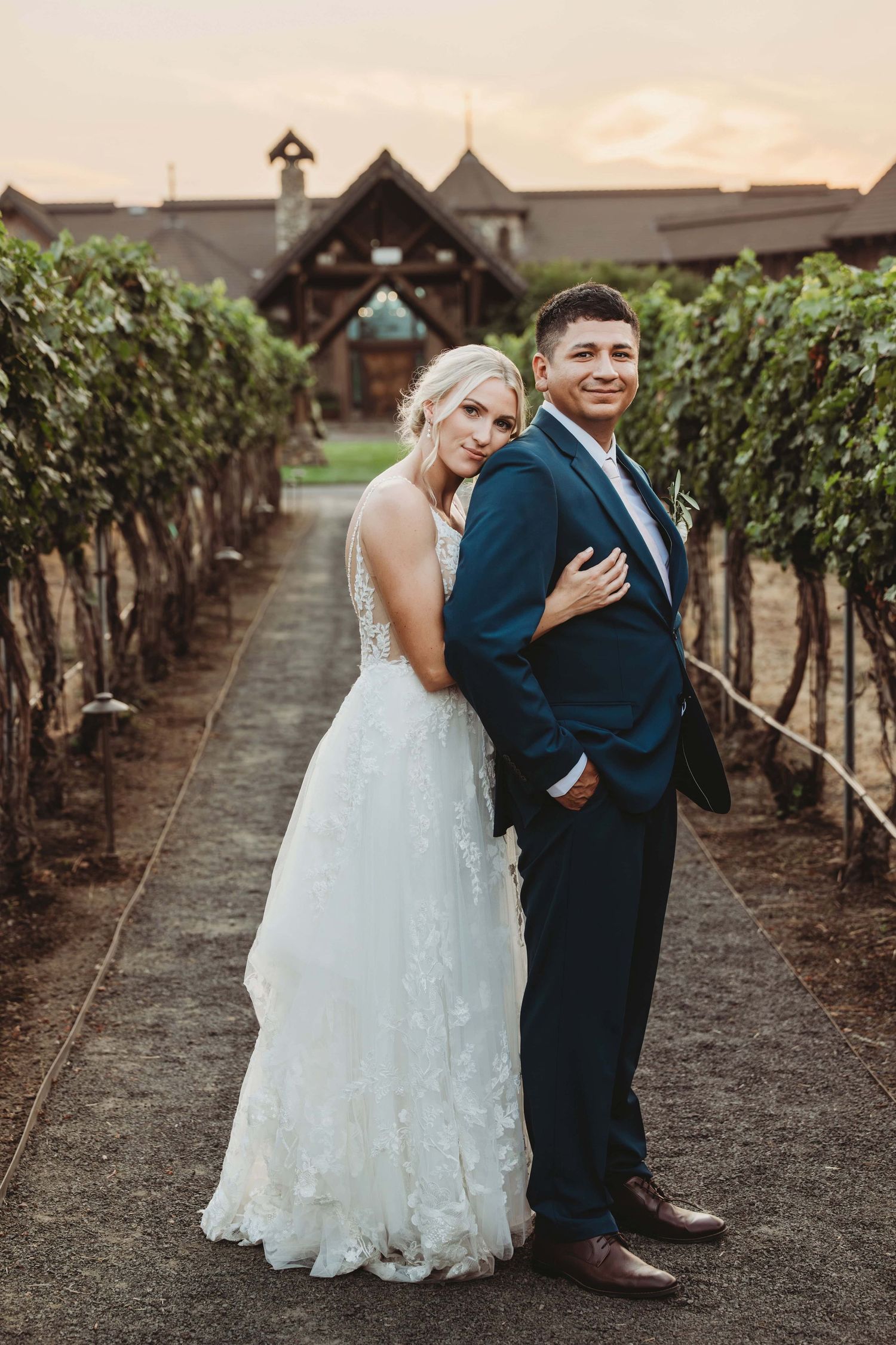 A portrait of a bride and groom standing in a vineyard taken by a Walla Walla wedding photographer.