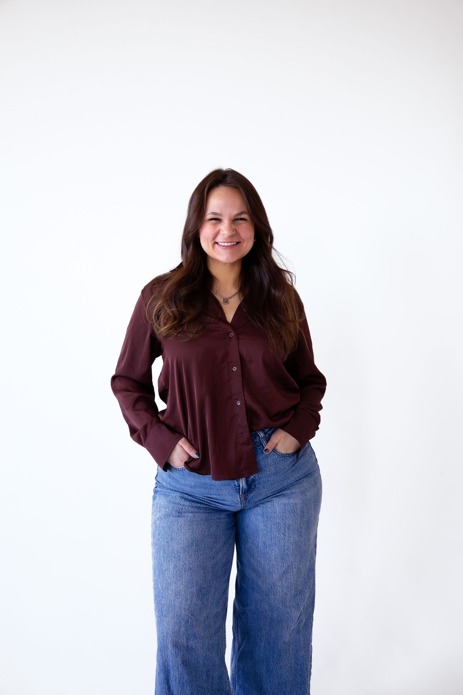 Fashion photo series showing casual outfit with burgundy button-down shirt and blue jeans against white background.