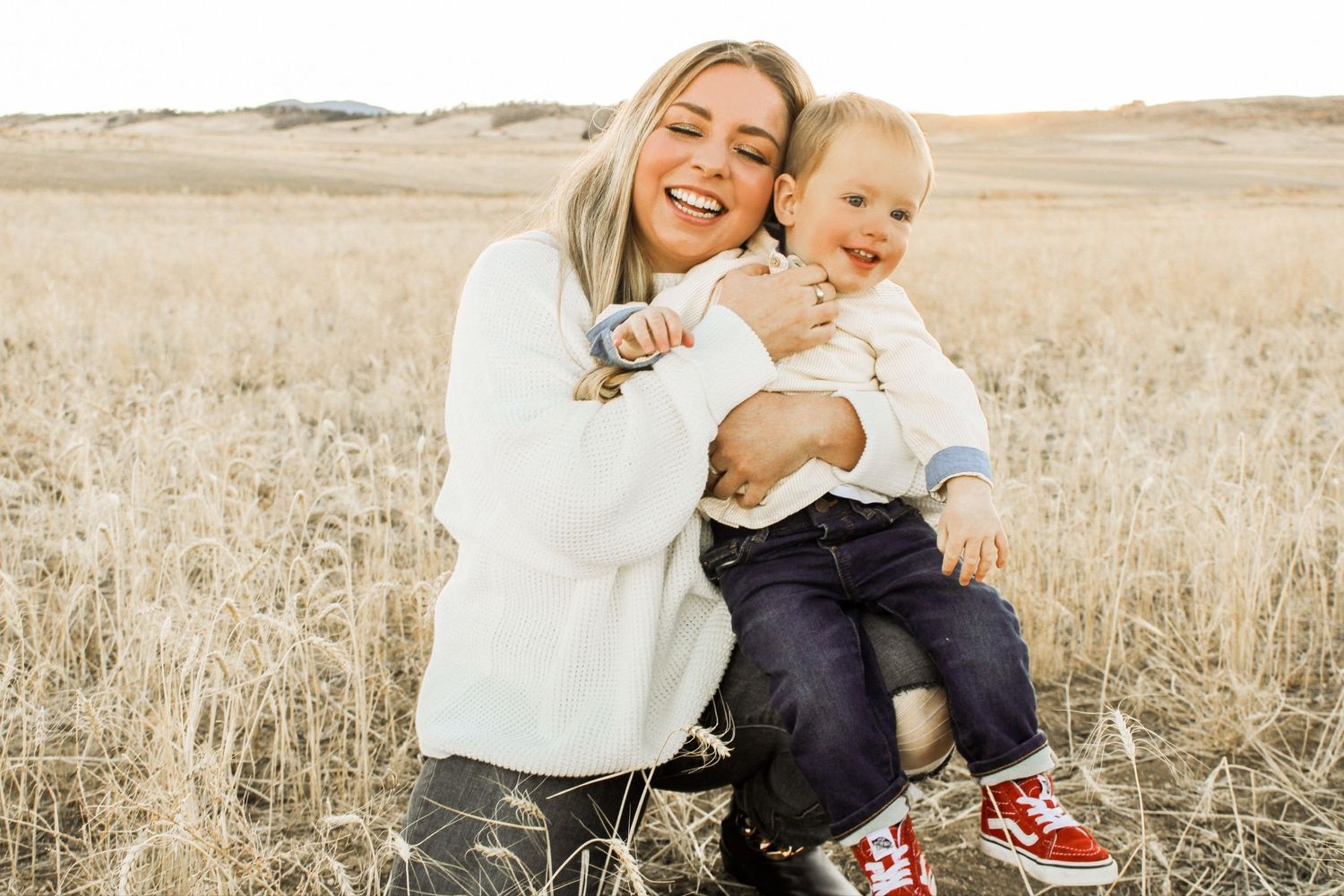 Joyful family moments captured in golden field during sunset.
