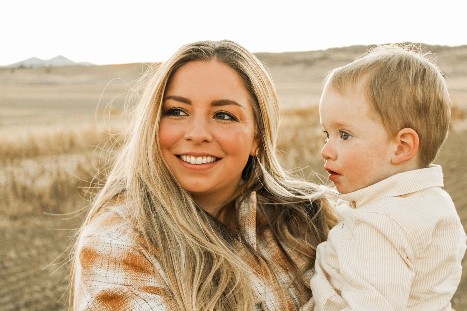 Mother and child sharing joyful moment in natural outdoor setting.