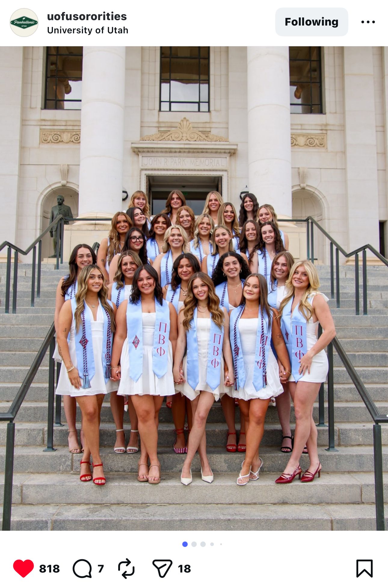 Members in matching blue and white outfits gathered on university building steps.