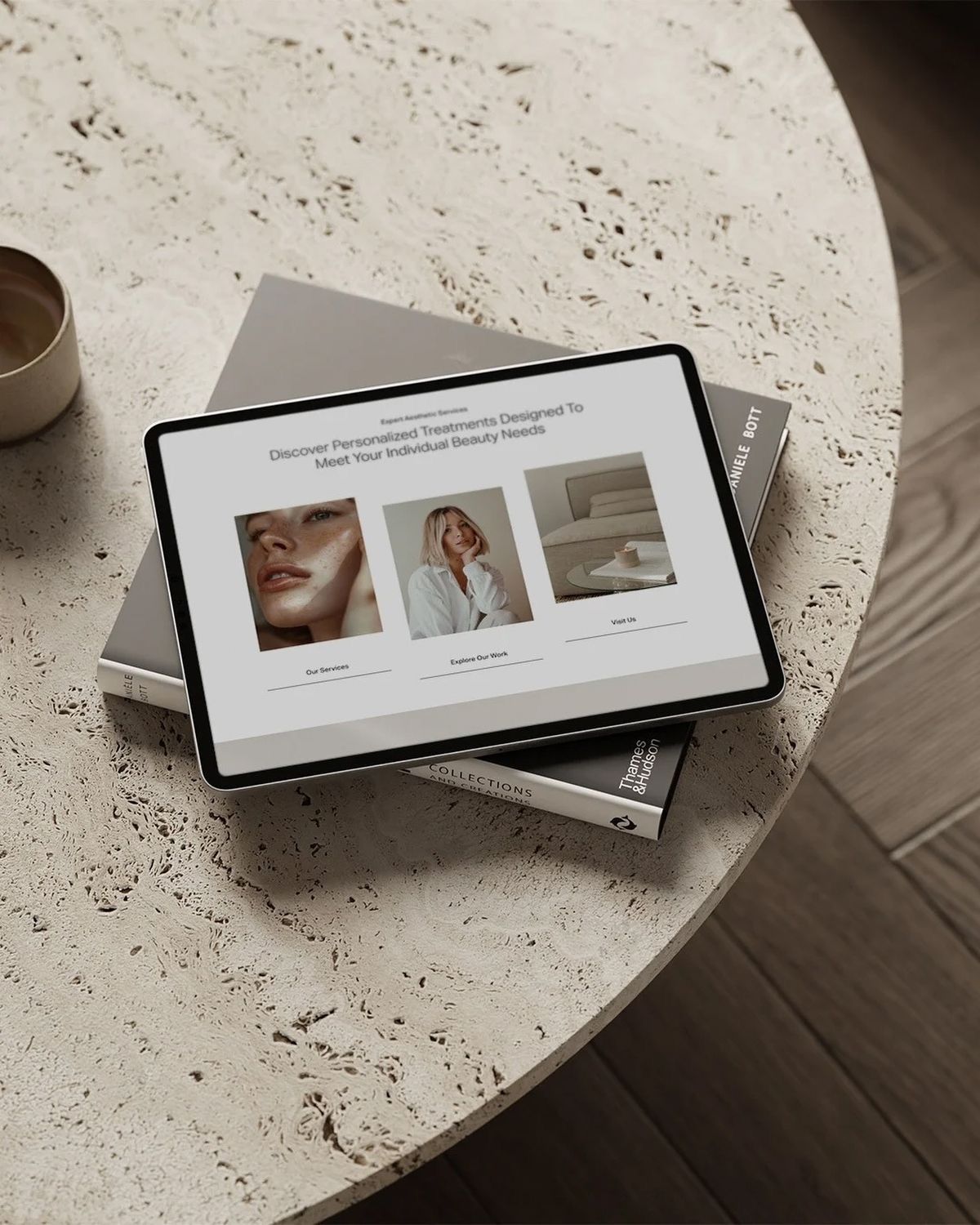 Minimalist website design mockups displayed on digital tablets against a textured white surface in moody lighting. Kangaroo Island Haus Home