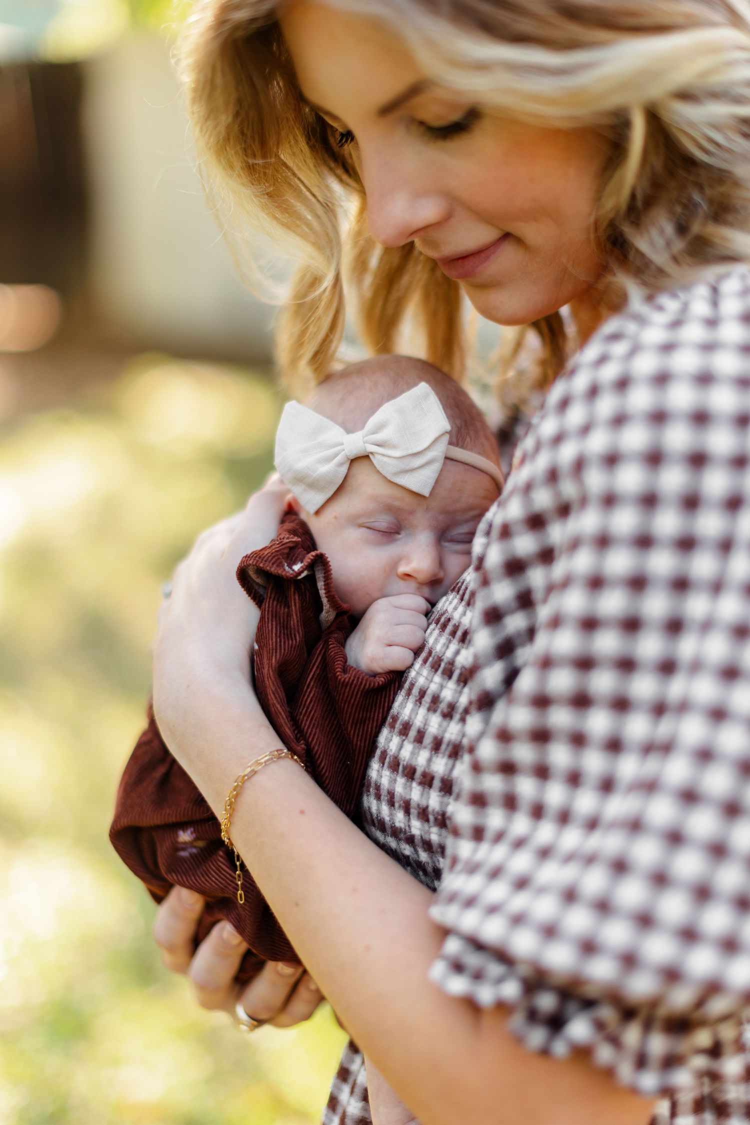 Young mother holding her sleeping baby for a portrait by Memphis wedding photographer Emily Joy Photography