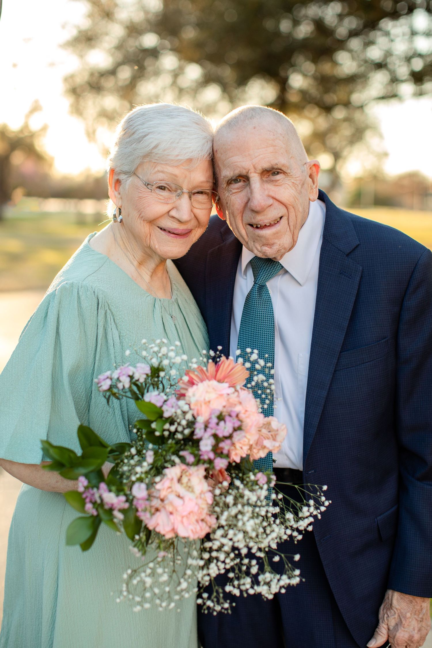 An elderly couple smiles on their anniversary for a portrait by Emily Joy Photography, now a wedding photographer in Memphis, TN.