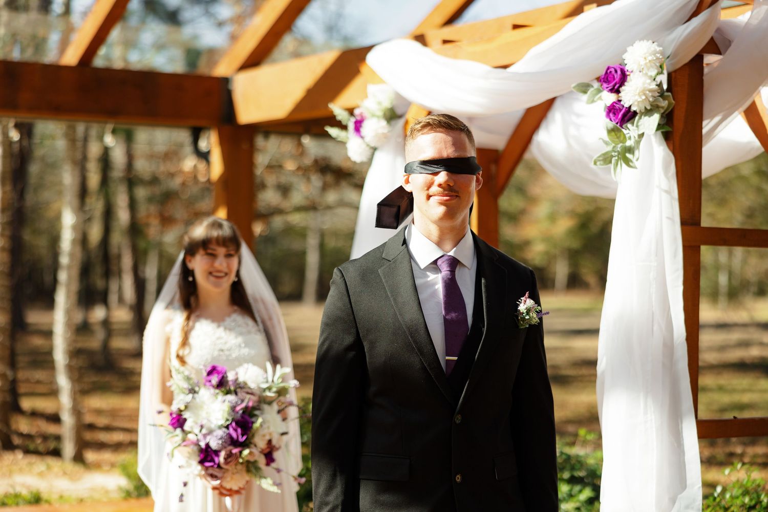 A groom is blindfolded right before he does the first look with his bride.