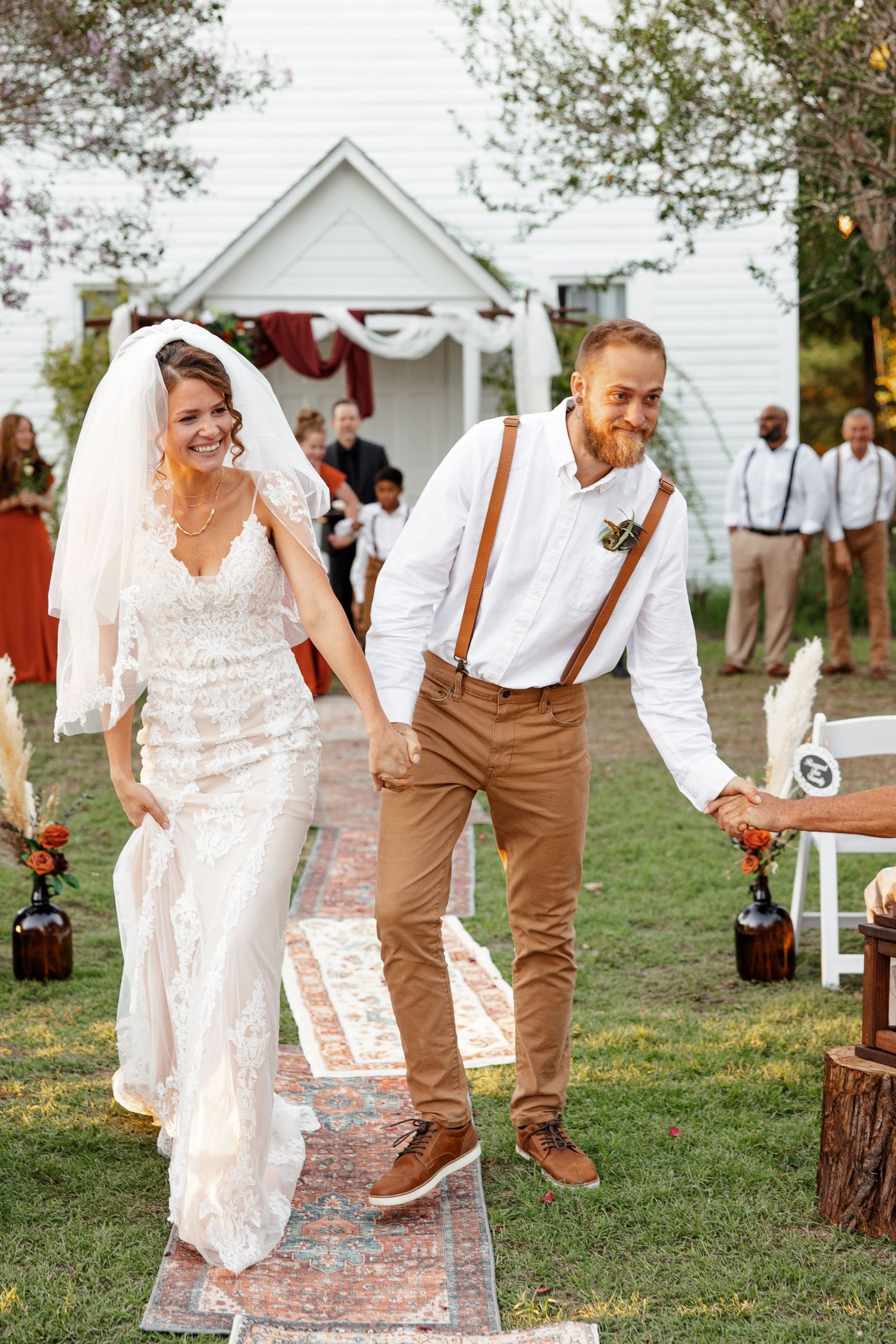 Husband and wife recess joyfully after outdoor wedding photographed by Emily Joy Photography, now a wedding photographer in Memphis, TN.