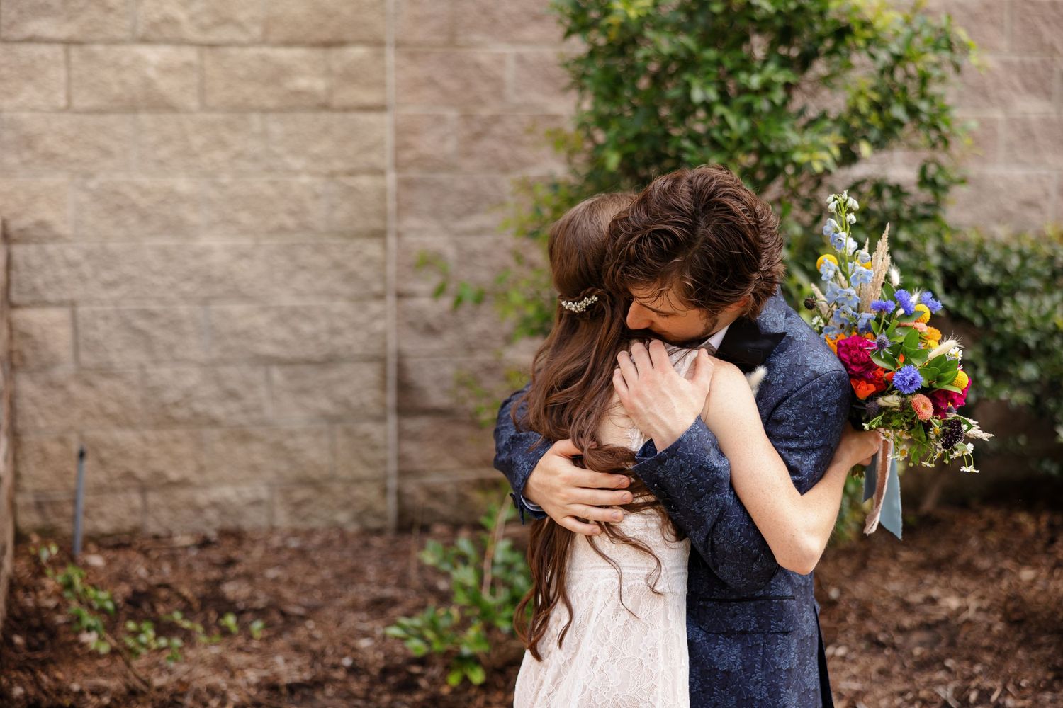 Bride and groom hug after first look for a portrait by Memphis wedding photographer Emily Joy Photography