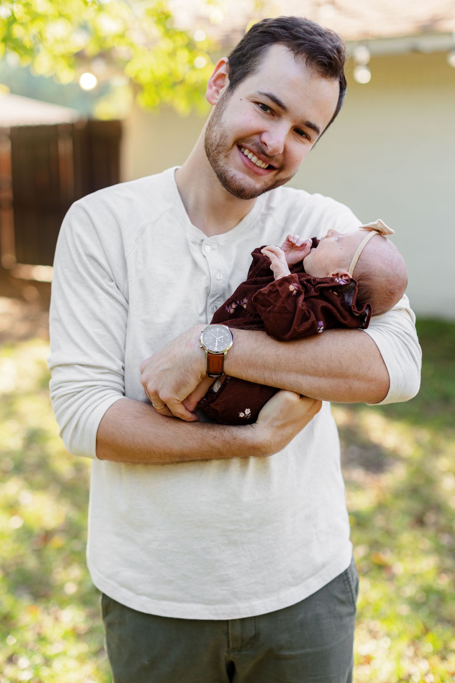 Young father holds his baby girl for a portrait by Memphis wedding photographer Emily Joy Photography
