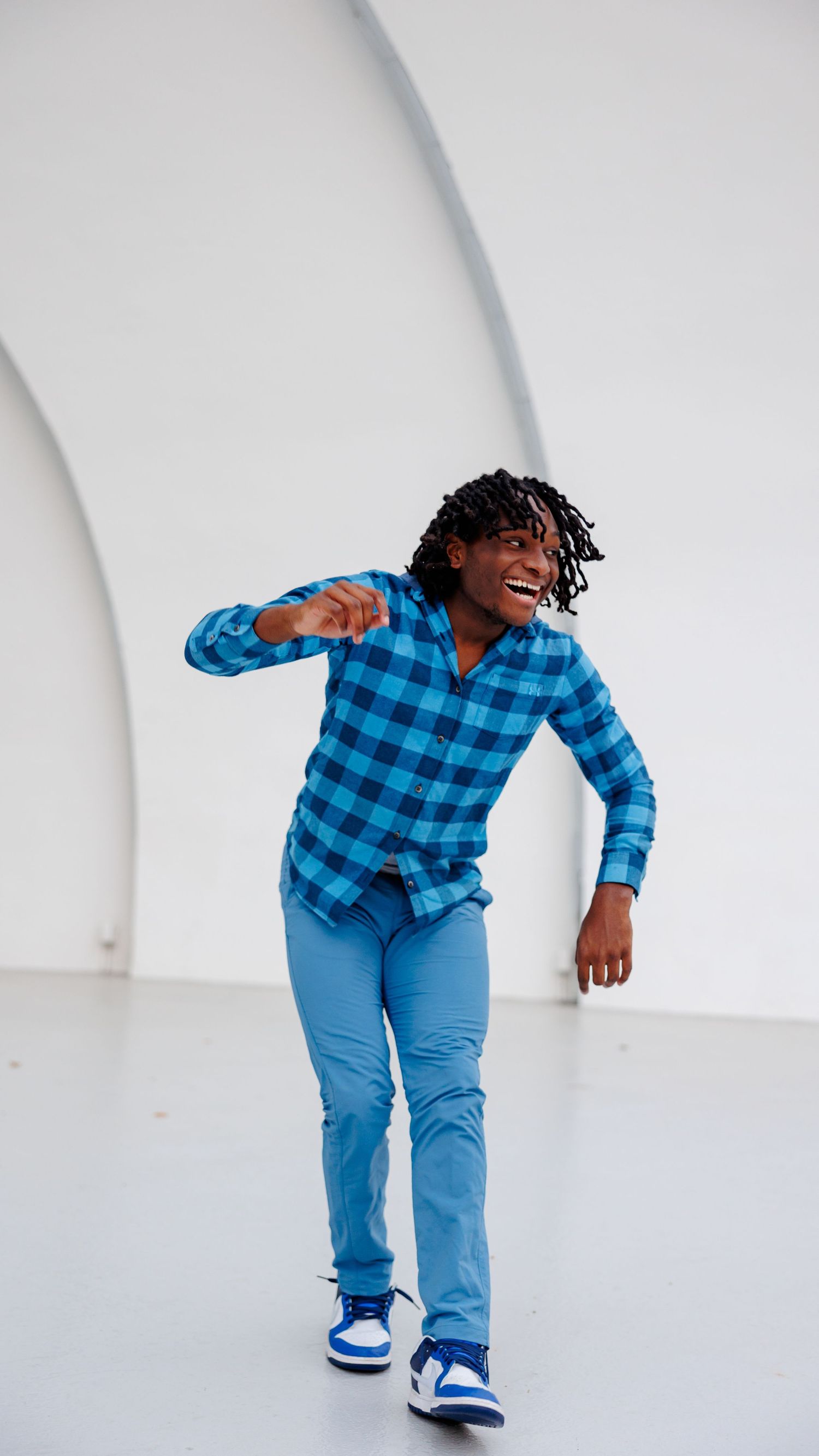 A senior boy dances for a candid portrait at Overton Park Shell stage.