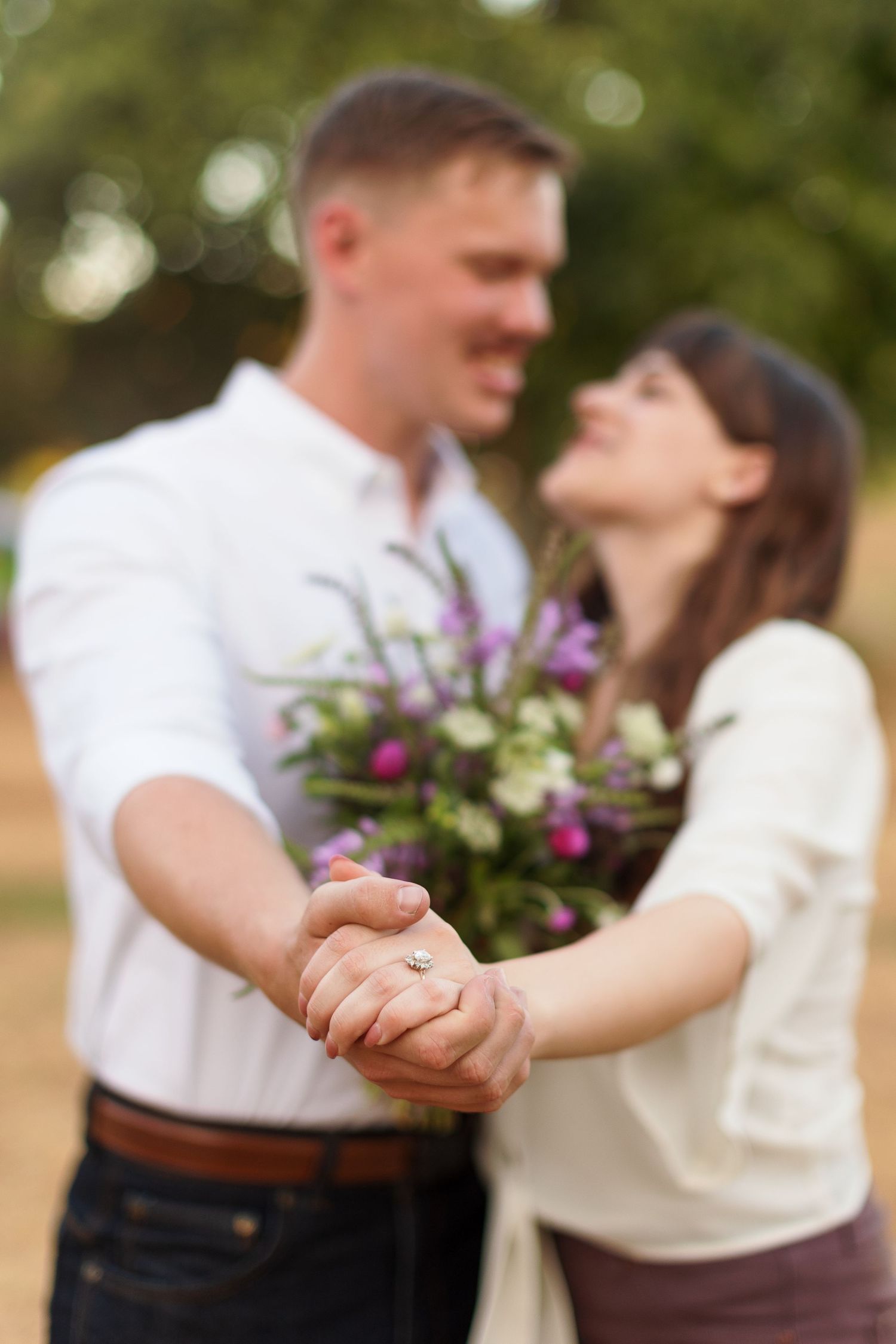 Engaged couple shows off ring for a portrait by Emily Joy Photography, now a wedding photographer in Memphis, TN.