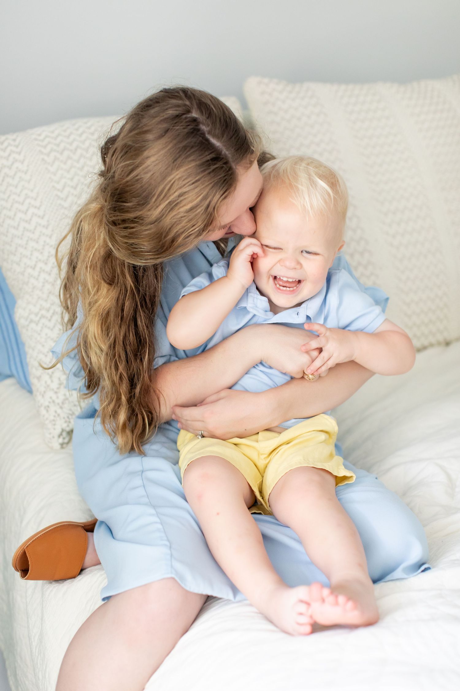 A mother tickles her toddler boy for a portrait by Emily Joy Photography, now a wedding photographer in Memphis, TN.