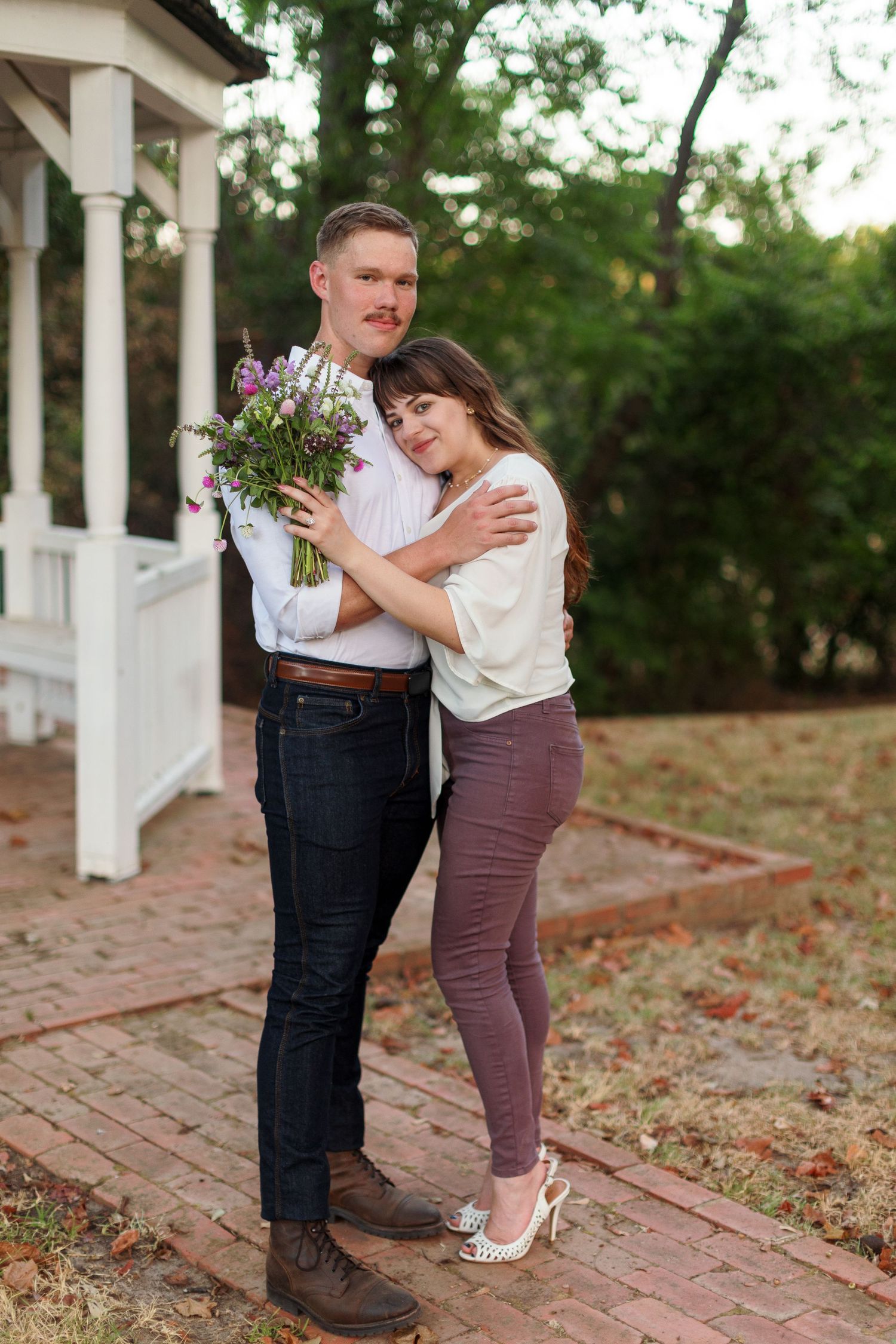 Engaged couple hugs for a portrait by Emily Joy Photography, now a wedding photographer in Memphis, TN.