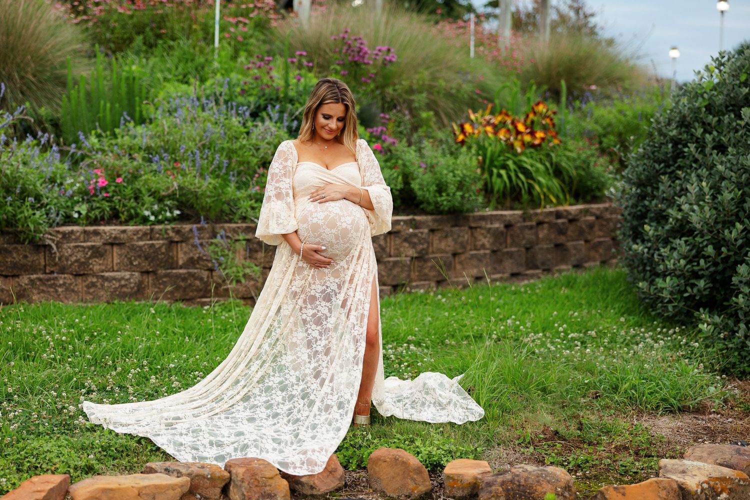 Expectant mother smiles down at her baby bump for a portrait by Memphis photographer Emily Joy Photography