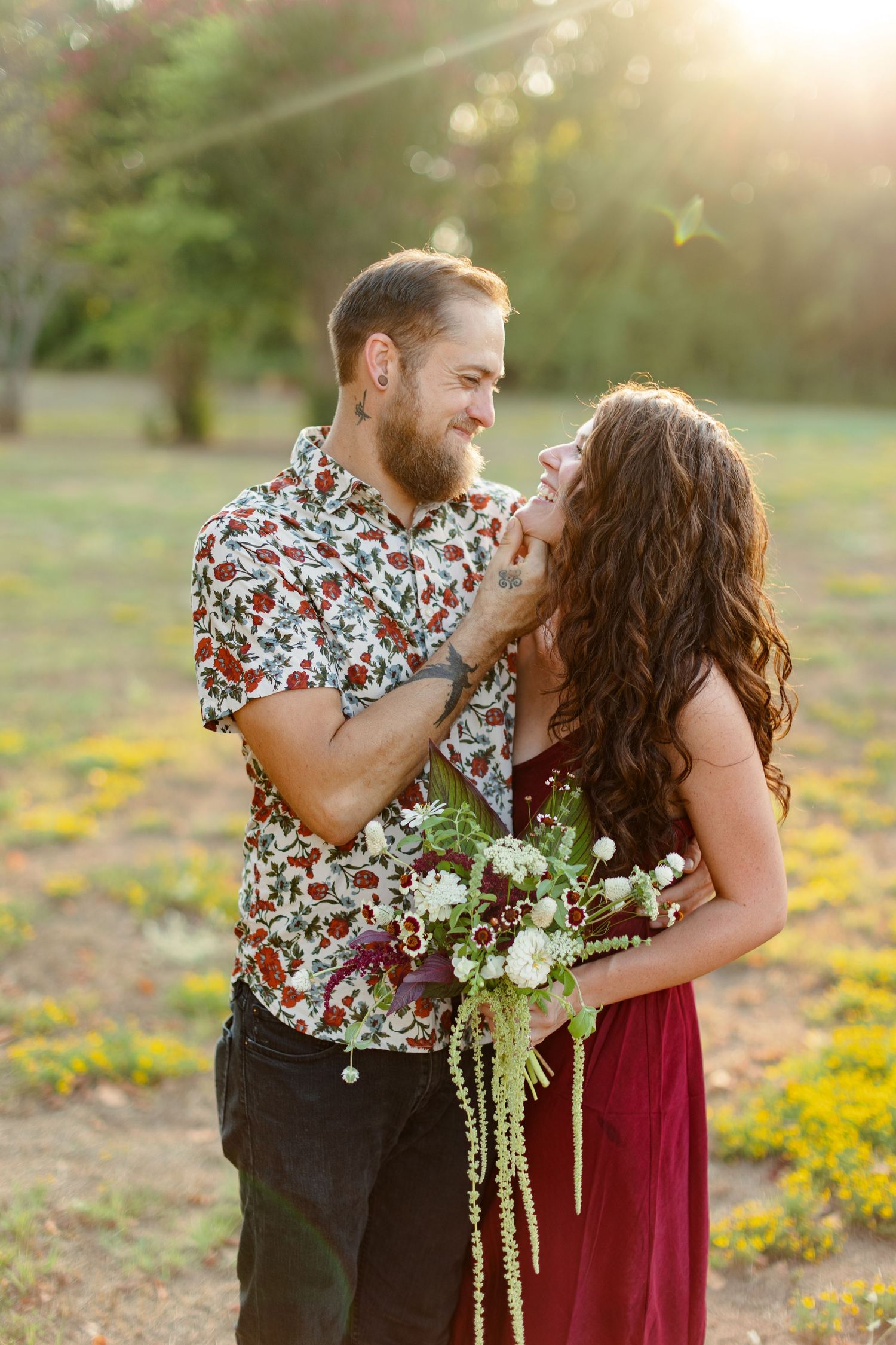 Engaged couple looks at each other and laughs for a portrait  by Emily Joy Photography, now a wedding photographer in Memphis, TN.
