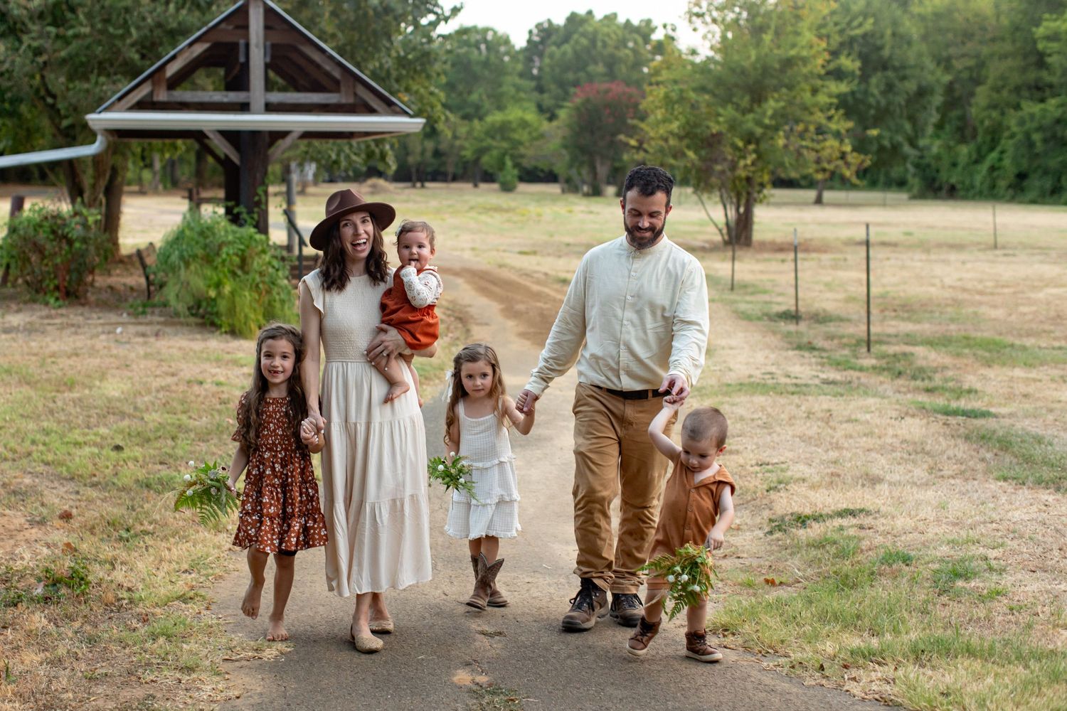 Natural light candid portrait of family of six walking for a portrait  by Emily Joy Photography, now a wedding photographer in Memphis, T