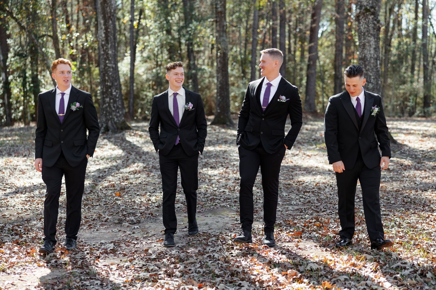 A groom and his three groomsmen enjoying a stroll.