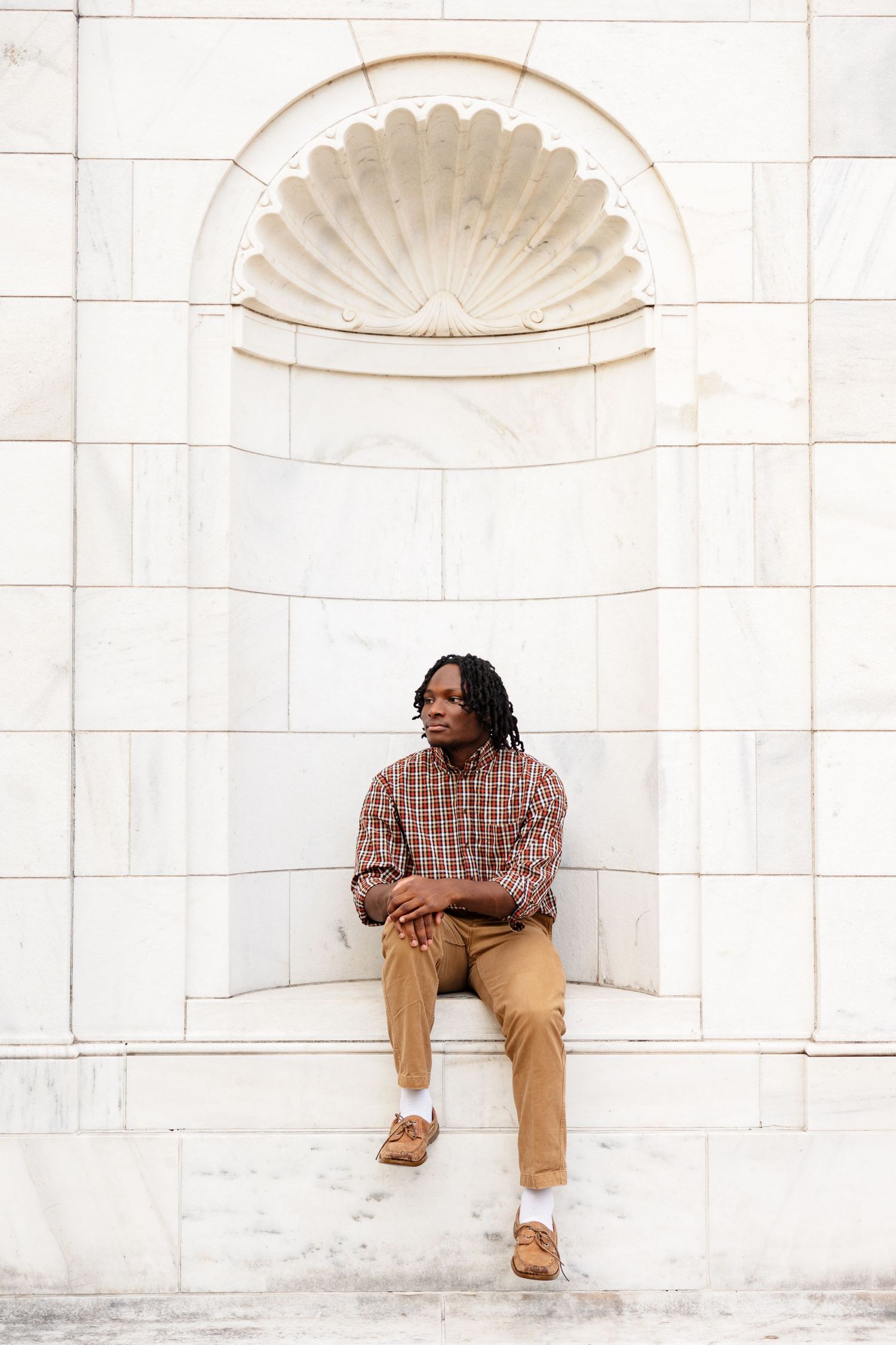 A senior boy framed in some wall architecture at the Brooks Museum in Memphis, TN.