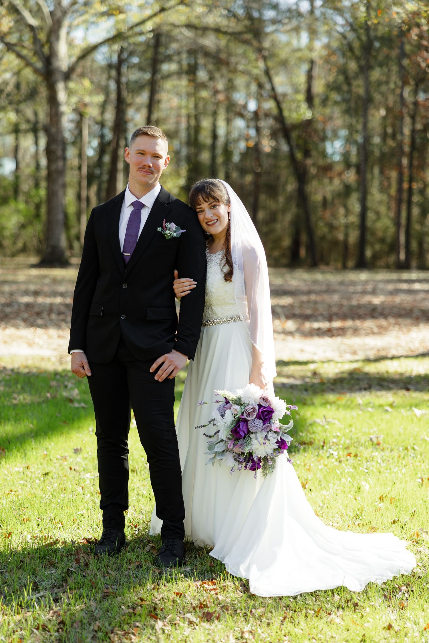 A classic portrait of a bride and groom smiling at the camera