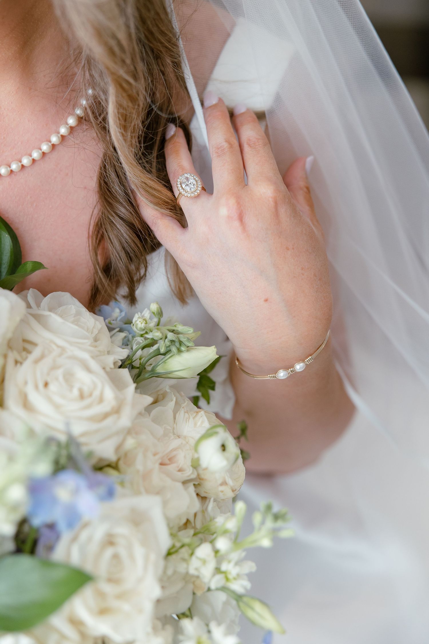 A detail shot of a bride's engagement ring, veil, and bouquet in a portrait by Emily Joy Photography, wedding photographer in Memphis, TN.
