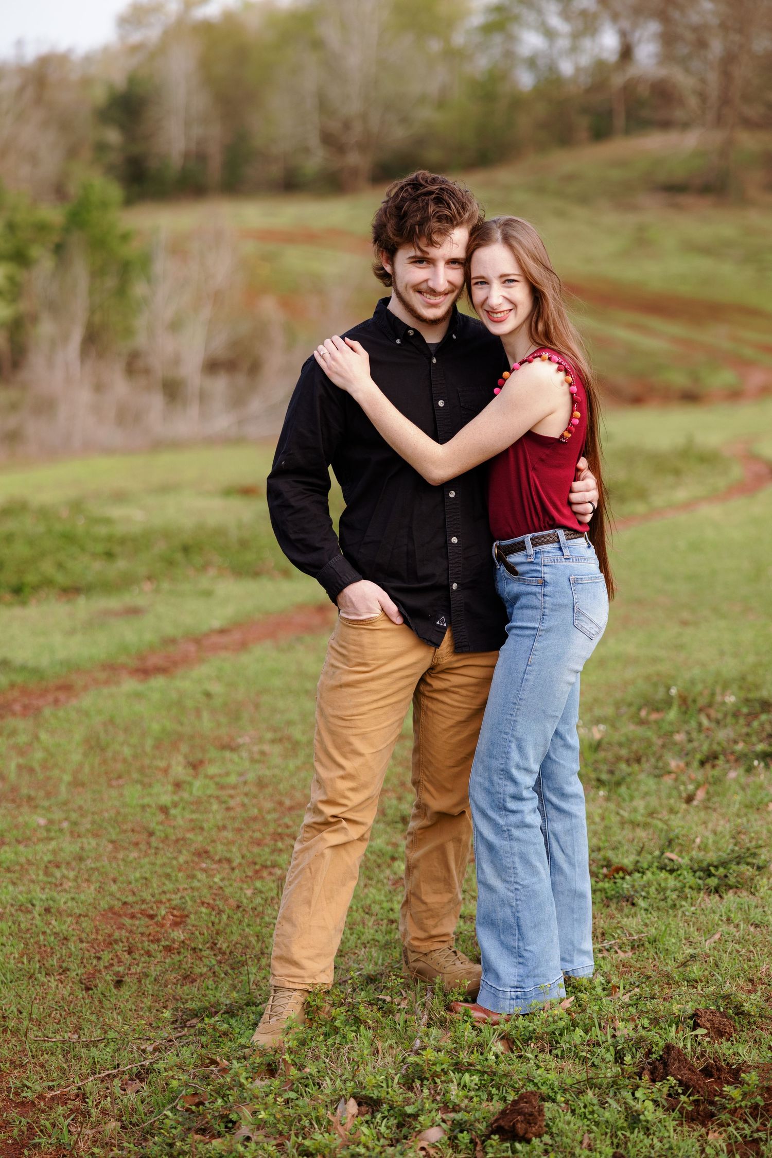 Young couple hugs and smiles at the camera for a portrait by Memphis wedding photographer Emily Joy Photography