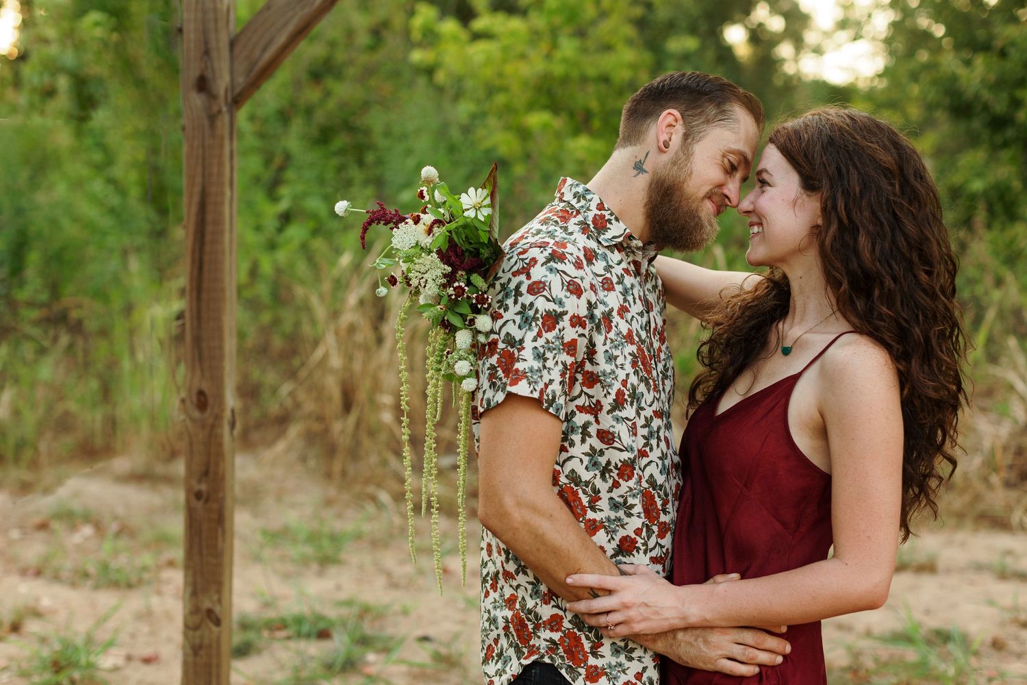 Engaged couple smiles at each other for a portrait by Nacogdoches photographer Emily Joy Photography