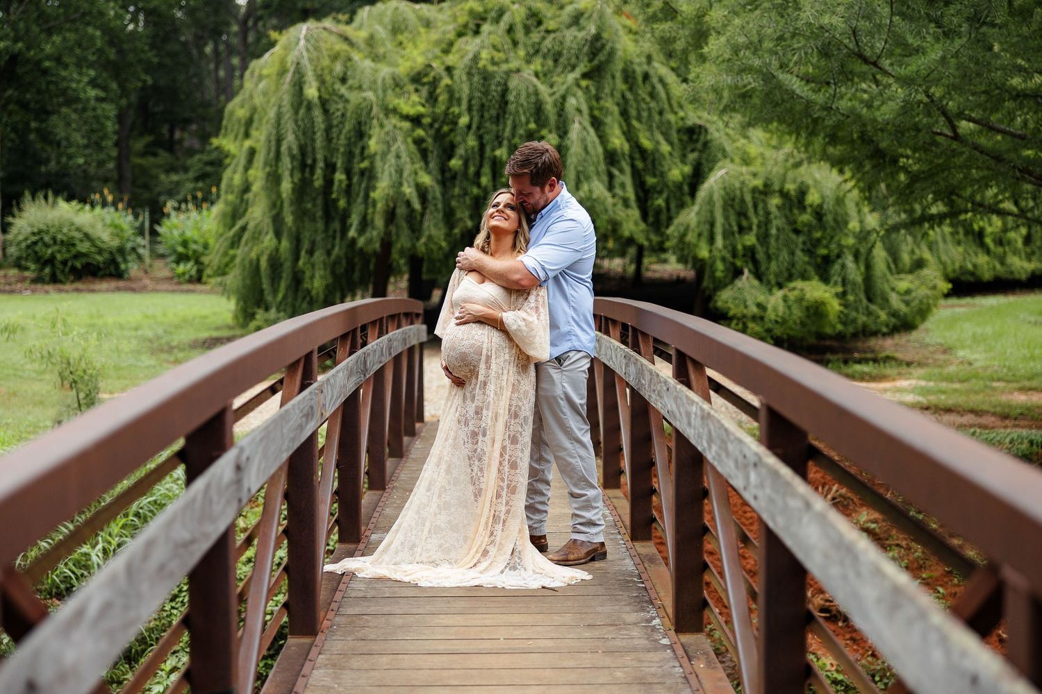 Husband kisses his pregnant wife for a portrait by Memphis photographer Emily Joy Photography