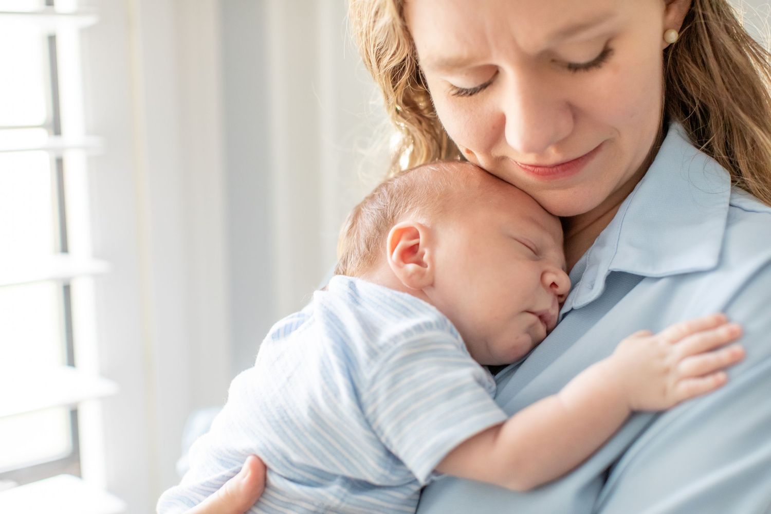 A newborn boy sleeps on his mother's chest for a portrait by Emily Joy Photography, now a wedding photographer in Memphis, TN.