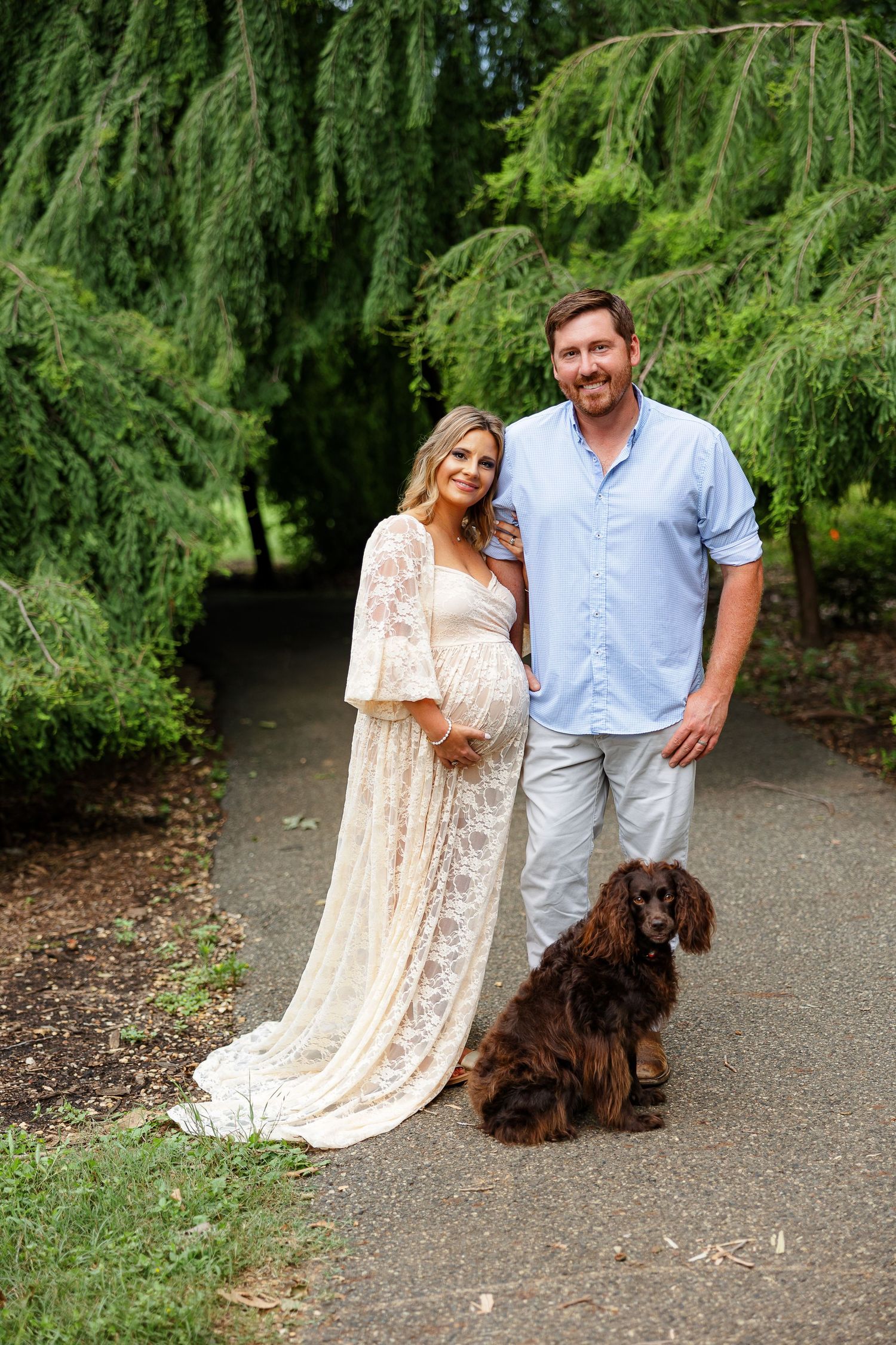 Expectant couple pose with their dog for a portrait by Memphis photographer Emily