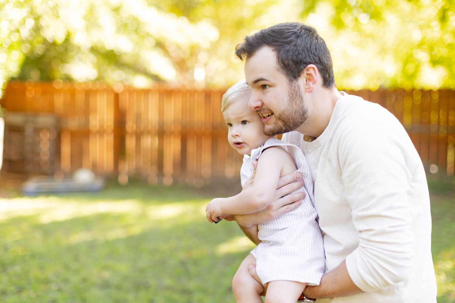 Young father and toddler play in backyard for a portrait  by Memphis wedding photographer Emily Joy Photography