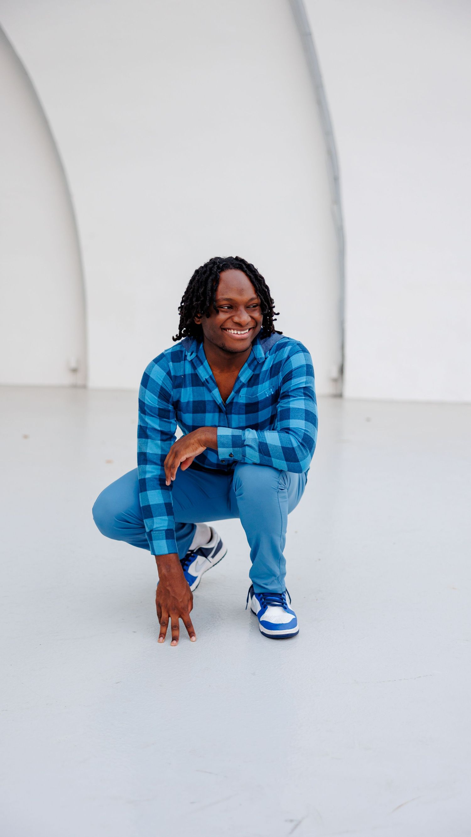 A senior boy poses for a portrait at Overton Park Shell stage.