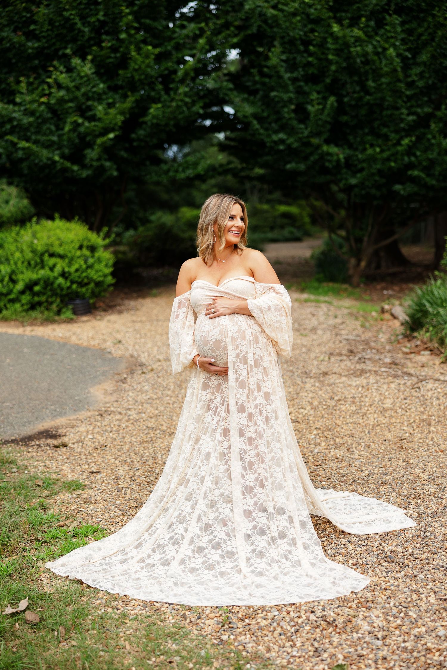 Expectant mother in a glamorous gown smiles off-camera for a portrait by Memphis photographer Emily Joy Photography