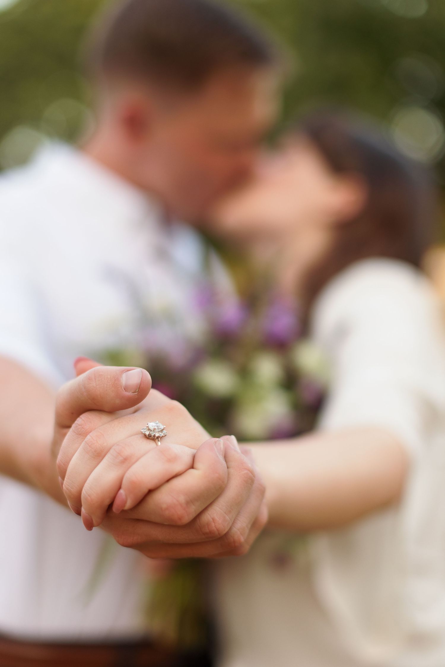 Engaged couple shows off ring while kissing for a portrait by Emily Joy Photography, now a wedding photographer in Memphis, TN.