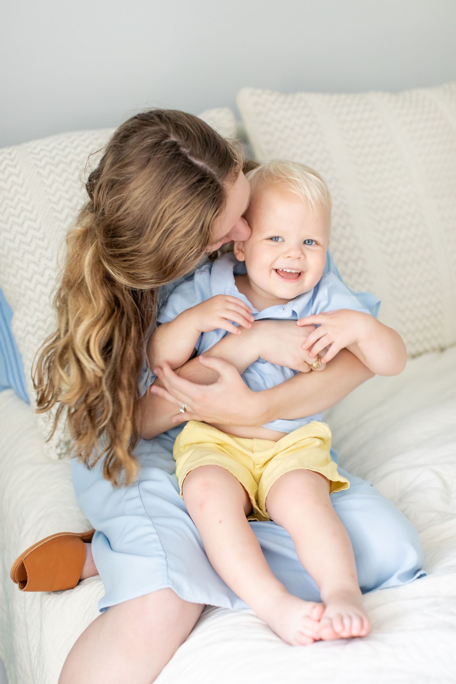 A mother kisses her toddler boy for a portrait by Emily Joy Photography, now a wedding photographer in Memphis, TN.