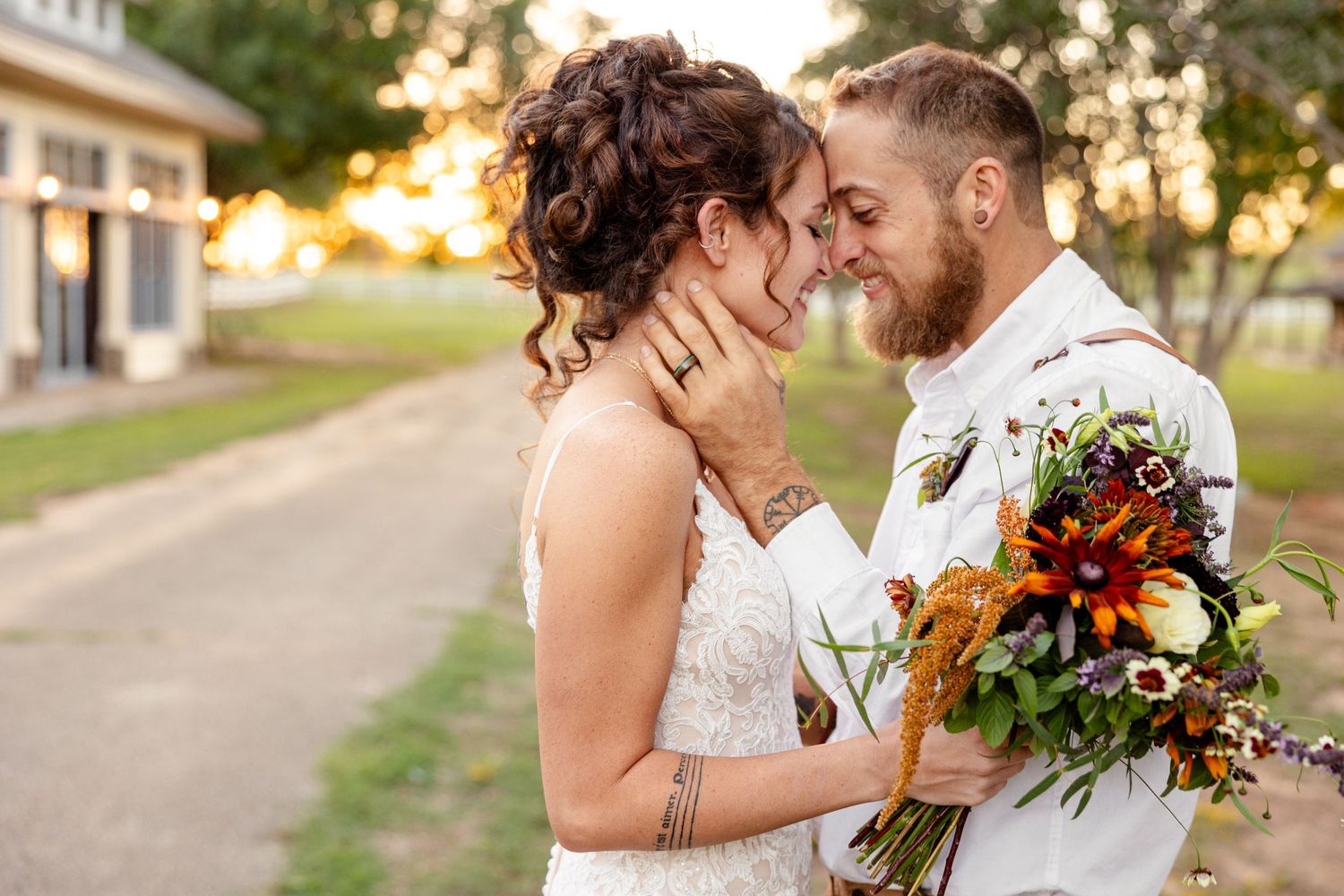 Bride and Groom smile at each other during sunset portrait by Nacogdoches photographer Emily Joy Photography