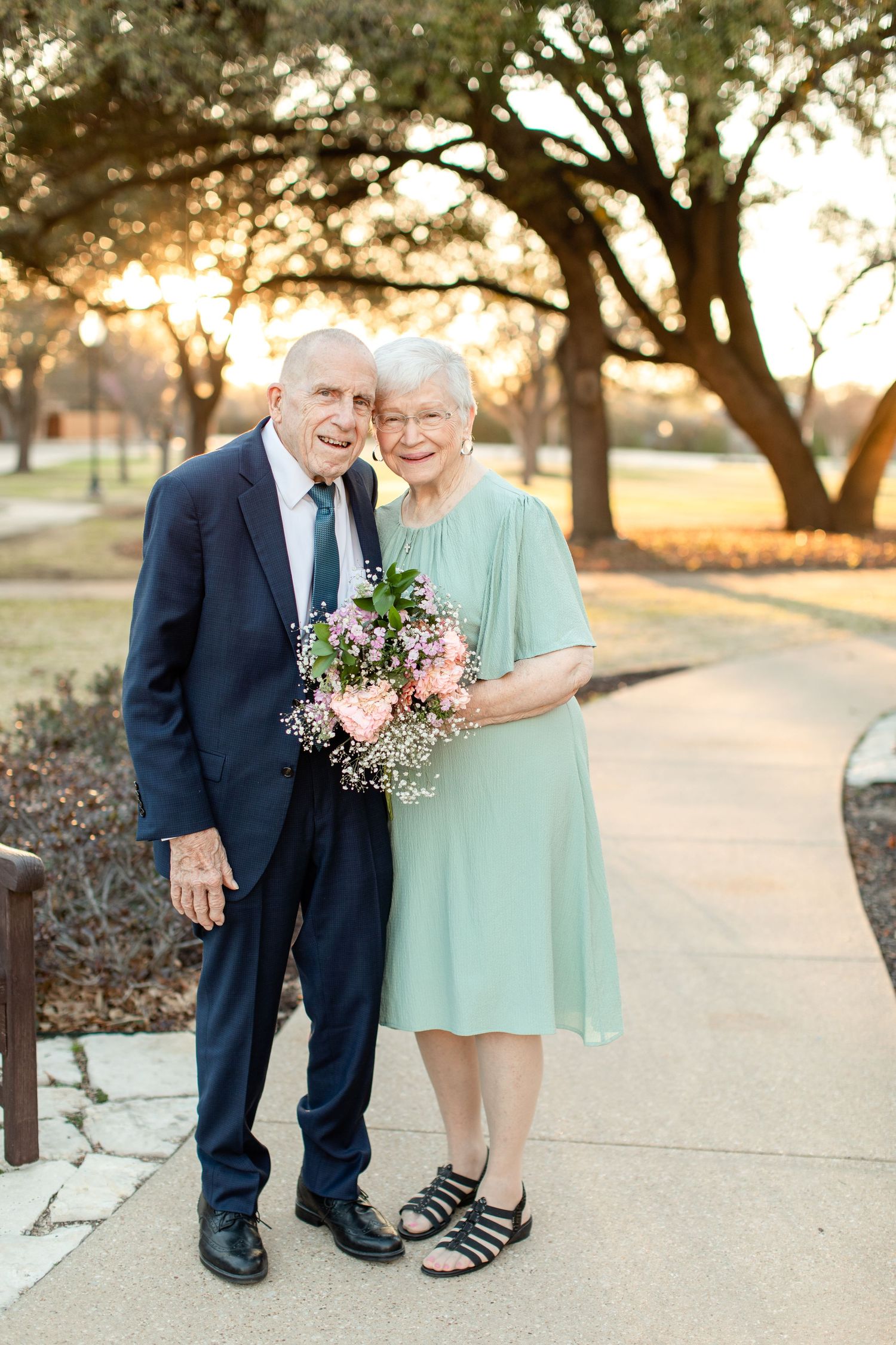 An elderly married couple smiling at sunset for a portrait by Emily Joy Photography, now a wedding photographer in Memphis, TN.