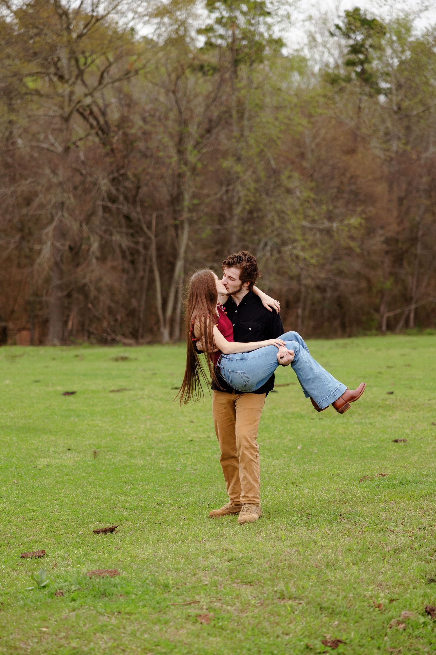 A young man holds his bride-to-be for a kiss in a portrait by Memphis wedding photographer Emily Joy Photography